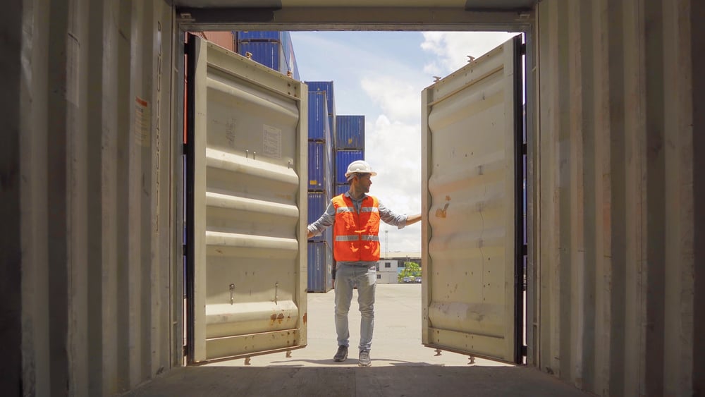 man opening freight shipping container