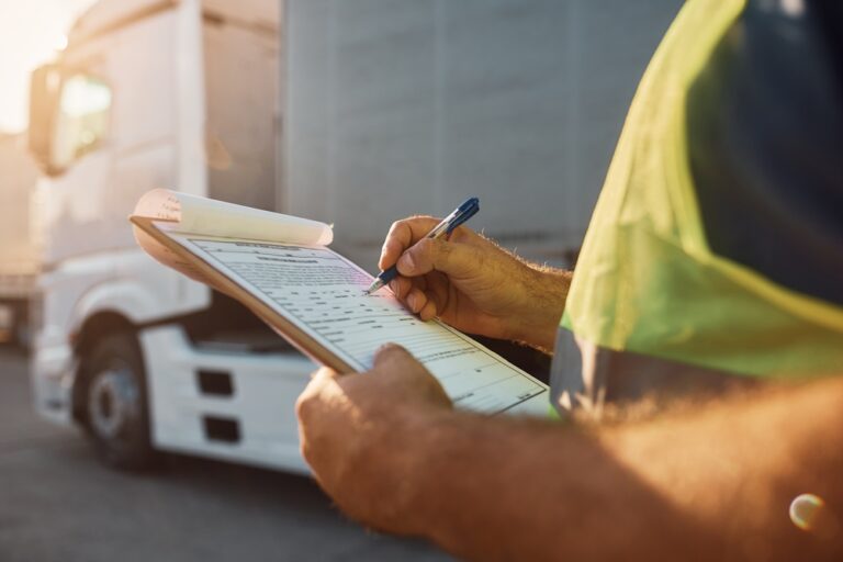 Logistics professional reviewing a bill of lading for freight shipment.